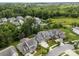 An aerial view showing lush landscaping, neighborhood pool, and backyard at 11329 Fullerton Place Nw Dr, Huntersville, NC 28078