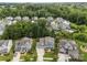 An aerial view showcasing neighborhood streets with well-maintained lawns and backyard pools at 11329 Fullerton Place Nw Dr, Huntersville, NC 28078