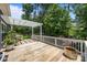 Spacious wooden deck with white railings and pergola, backing up to a private wooded area at 11329 Fullerton Place Nw Dr, Huntersville, NC 28078