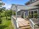 Inviting back deck with a white pergola, overlooking a well-manicured lawn and mature trees at 11329 Fullerton Place Nw Dr, Huntersville, NC 28078