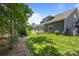 Expansive backyard with a large deck, lush lawn, and mature trees, perfect for outdoor living at 11329 Fullerton Place Nw Dr, Huntersville, NC 28078