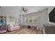 Bright playroom with hardwood floors, pink couch, toys and a large window at 11329 Fullerton Place Nw Dr, Huntersville, NC 28078