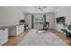 Spacious, sunlit bedroom featuring a ceiling fan, window, and desk area with built-in cabinets and drawers at 11329 Fullerton Place Nw Dr, Huntersville, NC 28078