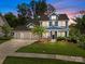 Charming two-story home with blue siding, landscaped front yard, and a three-car garage on a beautiful lot at 11329 Fullerton Place Nw Dr, Huntersville, NC 28078