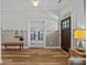 Bright foyer featuring wood floors, paneled walls, and access to the kitchen and other living spaces at 11329 Fullerton Place Nw Dr, Huntersville, NC 28078