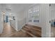 Upper hallway featuring wood steps, French doors, and light colored walls at 11329 Fullerton Place Nw Dr, Huntersville, NC 28078