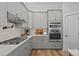 Well-equipped kitchen with stainless appliances, double ovens, and custom cabinets at 11329 Fullerton Place Nw Dr, Huntersville, NC 28078