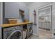 Well-organized laundry room boasts plenty of storage and a modern washer and dryer for your convenience at 11329 Fullerton Place Nw Dr, Huntersville, NC 28078