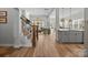Open-concept living room and kitchen with wood floors and plenty of natural light at 11329 Fullerton Place Nw Dr, Huntersville, NC 28078