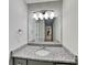 Bathroom vanity featuring gray cabinets, stone counters, and an oversized mirror at 120 Todd Nw Dr, Concord, NC 28025