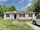 Charming single-story home featuring a welcoming entrance, black shutters, and well-maintained lawn at 120 Todd Nw Dr, Concord, NC 28025