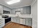 Modern kitchen featuring stainless steel appliances, granite countertops, subway tile backsplash, and gray painted cabinetry at 120 Todd Nw Dr, Concord, NC 28025