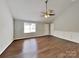 Spacious living room with a vaulted ceiling, a ceiling fan, and stylish wood-look floors creates a welcoming ambiance at 120 Todd Nw Dr, Concord, NC 28025