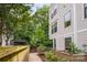 Serene backyard with lush greenery, a wooden fence, and a charming pergola creates a private outdoor retreat at 1207 E 36Th St, Charlotte, NC 28205