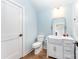 Well-lit bathroom featuring a farmhouse sink, white cabinets, and modern fixtures at 1207 E 36Th St, Charlotte, NC 28205