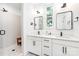 A modern bathroom features double sinks, sleek fixtures, and a glass-enclosed shower with tiled walls at 1207 E 36Th St, Charlotte, NC 28205