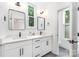 A modern bathroom features double sinks, sleek fixtures, and a toilet room with tiled floors at 1207 E 36Th St, Charlotte, NC 28205