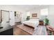 A cozy bedroom with hardwood floors, a ceiling fan, and an ensuite bathroom with double doors at 1207 E 36Th St, Charlotte, NC 28205