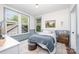 Cozy bedroom with natural light, wainscoting, and warm accents at 1207 E 36Th St, Charlotte, NC 28205