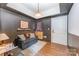Comfortable bonus room with hardwood floors, dark accent wall, and stylish furnishings at 1207 E 36Th St, Charlotte, NC 28205