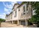 A row of modern townhouses with individual garages and sleek architectural design under a partly cloudy sky at 1207 E 36Th St, Charlotte, NC 28205