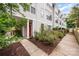 Charming townhome exterior with red door, sidewalk, and well-maintained landscaping at 1207 E 36Th St, Charlotte, NC 28205