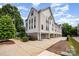 View of a modern townhouse community with manicured landscaping and sidewalks, featuring gray and white siding at 1207 E 36Th St, Charlotte, NC 28205
