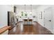 Modern kitchen with stainless steel appliances, white cabinets, and an island with seating at 1207 E 36Th St, Charlotte, NC 28205