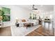 Bright living room with hardwood floors, large windows, and an open layout to kitchen at 1207 E 36Th St, Charlotte, NC 28205
