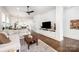 Open-concept living room with hardwood floors and built-in media cabinet at 1207 E 36Th St, Charlotte, NC 28205