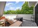 Relaxing patio with wicker furniture, barbecue grill, and scenic views of lush greenery and blue sky at 1207 E 36Th St, Charlotte, NC 28205