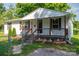 Welcoming covered porch featuring wood railings, steps, and a manicured garden bed at 1212 Frank Ext, Rock Hill, SC 29730