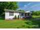 Inviting single story home featuring a classic covered front porch and green front lawn at 1212 Frank Ext, Rock Hill, SC 29730