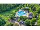 An aerial view showing a community pool, garden plots, a parking lot and plenty of shady trees at 12304 Huntersville Concord Rd, Huntersville, NC 28078