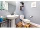 Powder room featuring pedestal sink, toilet, and decor at 12304 Huntersville Concord Rd, Huntersville, NC 28078