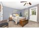 Cozy bedroom with a decorative metal bed frame, wooden chest, and neutral carpet at 12304 Huntersville Concord Rd, Huntersville, NC 28078
