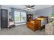 Comfortable bedroom featuring a ceiling fan, soft carpet, and a window overlooking the yard at 12304 Huntersville Concord Rd, Huntersville, NC 28078