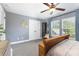 Spacious bedroom with a ceiling fan, closet, and large windows at 12304 Huntersville Concord Rd, Huntersville, NC 28078
