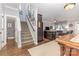 Home entryway featuring hardwood floors, staircase, and view of the kitchen and dining area at 12304 Huntersville Concord Rd, Huntersville, NC 28078