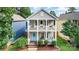 Charming two-story home with double front porches, bright blue door, and manicured landscaping at 12304 Huntersville Concord Rd, Huntersville, NC 28078