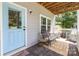 Inviting front porch with comfortable seating and a bright blue entry door at 12304 Huntersville Concord Rd, Huntersville, NC 28078