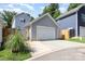 Detached garage with a white door, long driveway, and nice landscaping, offering privacy at 12304 Huntersville Concord Rd, Huntersville, NC 28078