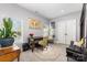 Home office featuring a world map, large windows, and a cozy seating area at 12304 Huntersville Concord Rd, Huntersville, NC 28078