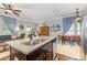 Open-concept kitchen showcasing a large island with a sink and dining area at 12304 Huntersville Concord Rd, Huntersville, NC 28078