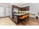 Modern kitchen with a granite countertop island, stainless steel appliances, and dark wood cabinetry at 12304 Huntersville Concord Rd, Huntersville, NC 28078