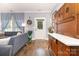 Comfortable living room with hardwood floors, gray sofa, and decorative antique cabinet at 12304 Huntersville Concord Rd, Huntersville, NC 28078