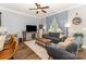 Open-concept living room with hardwood floors, comfortable seating, and a view into the kitchen at 12304 Huntersville Concord Rd, Huntersville, NC 28078