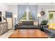 Inviting living room featuring a comfortable sofa, large window, and hardwood floors at 12304 Huntersville Concord Rd, Huntersville, NC 28078