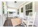 Inviting covered front porch with rocking chairs, perfect for relaxing outdoors at 12304 Huntersville Concord Rd, Huntersville, NC 28078