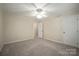 Bright bedroom with neutral carpet, white trim, ceiling fan, and two closets at 1330 5Th Ne St, Hickory, NC 28601